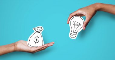 Startup supporting. Hands with dollar sign bag and light bulb over blue background, investor giving creator money